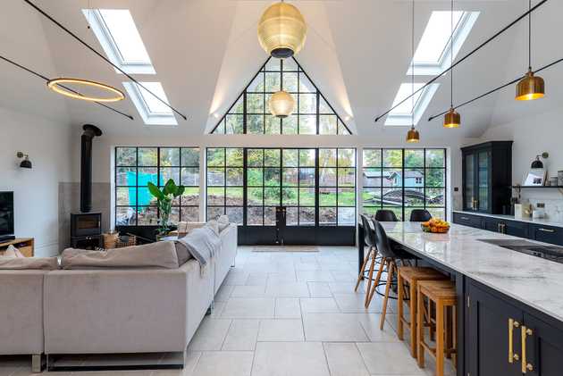 Modern kitchen design with roof windows and a glass wall