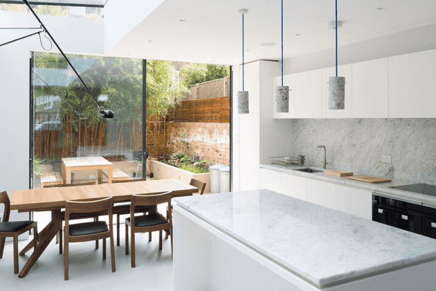 Modern white kitchen with wooden table