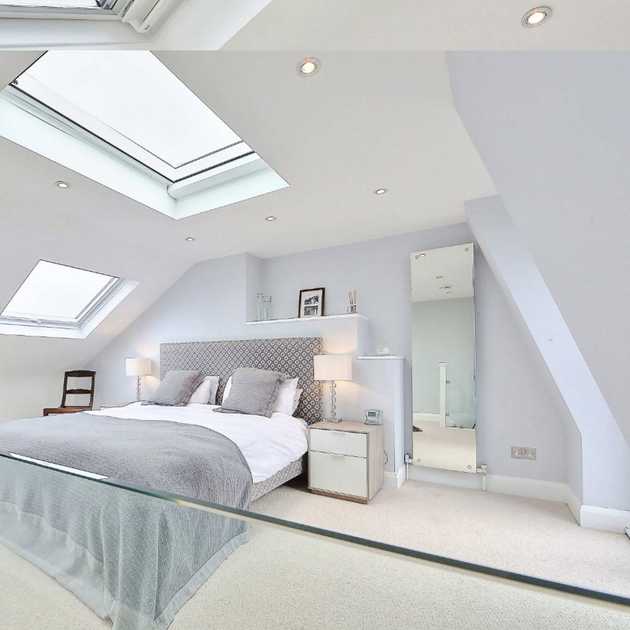 Attic loft bedroom design with roof window and natural light